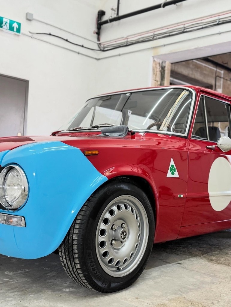 Classic Alfa Romeo in race livery, gleaming after detailing