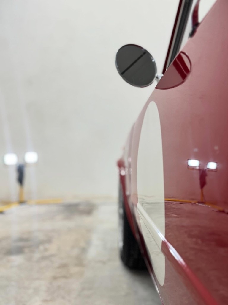 Deep gloss on a classic Alfa Romeo rear quarter and fuel filler