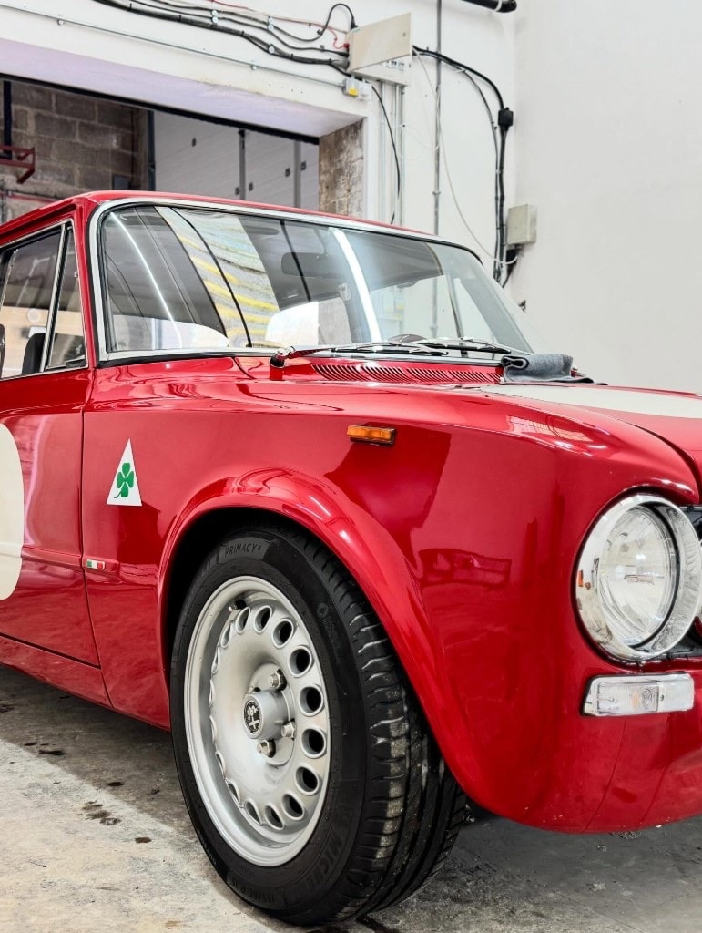 Freshly detailed classic red Alfa Romeo Giulia, front three-quarter