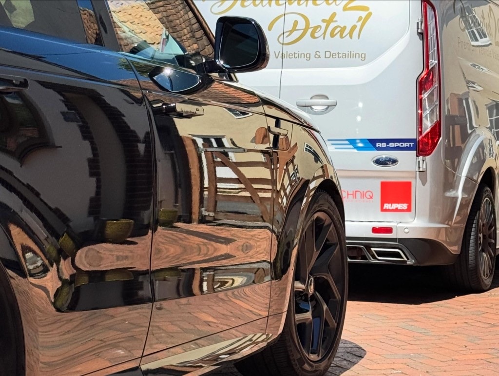 Mirror-like reflections on a freshly detailed black car