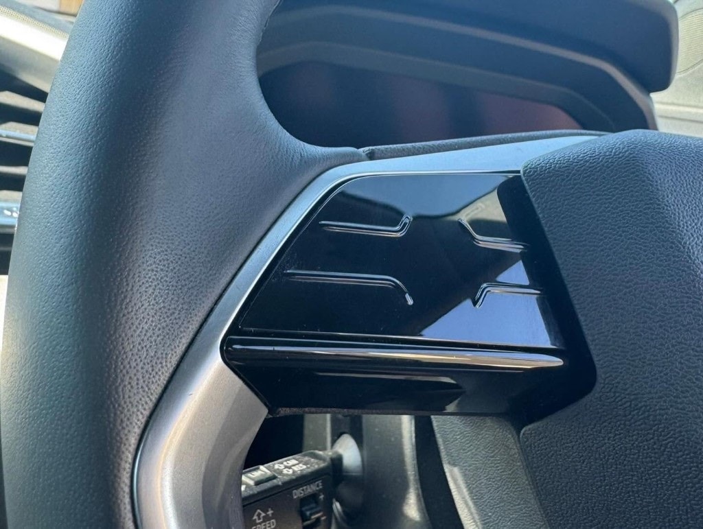Polished gloss-black steering wheel controls after an interior detail
